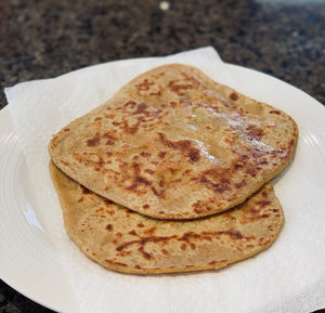 Flatbread made with chickpea flour and whole wheat flour , flavoured with spices, vegetables and aromatics.  